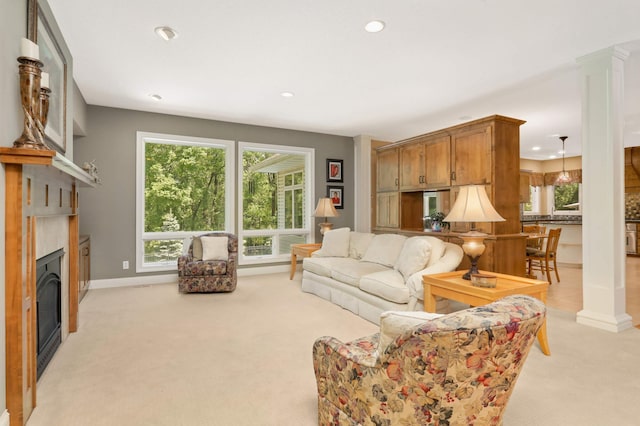 6209 Heather Pl NE, Fridley, MN 55432 - living room featuring light carpet, recessed lighting, ornate columns, a glass covered fireplace, and baseboards