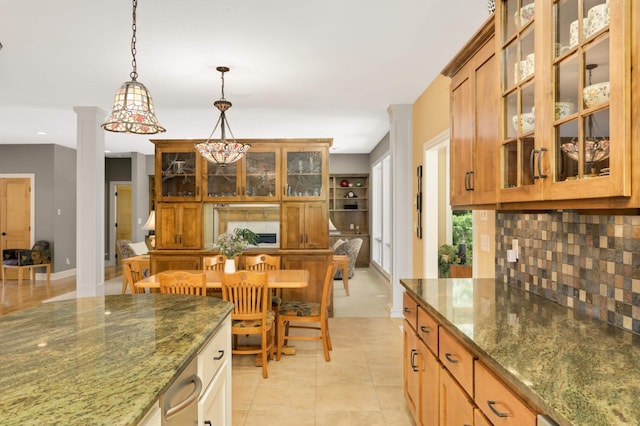 6209 Heather Pl NE, Fridley, MN 55432 - kitchen with backsplash, hanging light fixtures, dark stone counters, ornate columns, and recessed lighting