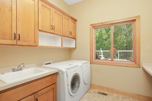 6209 Heather Pl NE, Fridley, MN 55432 - washroom featuring cabinet space, washer and dryer, and baseboards
