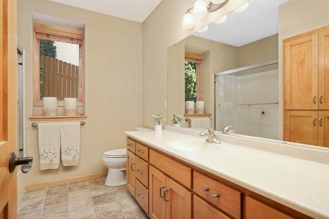 6209 Heather Pl NE, Fridley, MN 55432 - bathroom with vanity, toilet, baseboards, and an enclosed shower