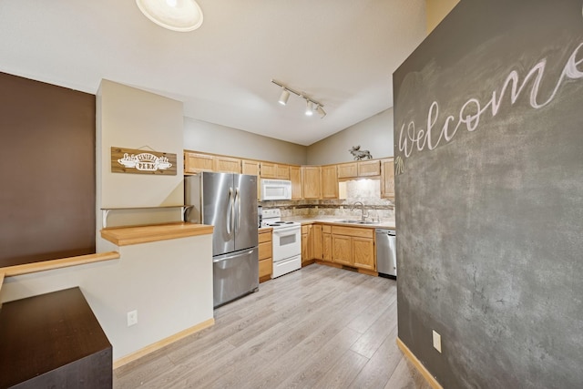 8260 Parkington Ave NE, Otsego, MN 55330 - kitchen featuring appliances with stainless steel finishes, a sink, light wood-style floors, rail lighting, and lofted ceiling