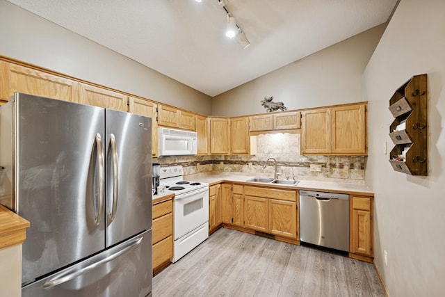 8260 Parkington Ave NE, Otsego, MN 55330 - kitchen featuring stainless steel appliances, a sink, lofted ceiling, light countertops, and light wood-type flooring