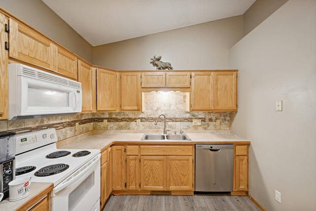 8260 Parkington Ave NE, Otsego, MN 55330 - kitchen with white appliances, a sink, backsplash, light countertops, and light wood finished floors