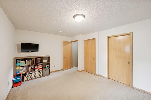 8260 Parkington Ave NE, Otsego, MN 55330 - unfurnished bedroom with carpet floors, baseboards, and a textured ceiling