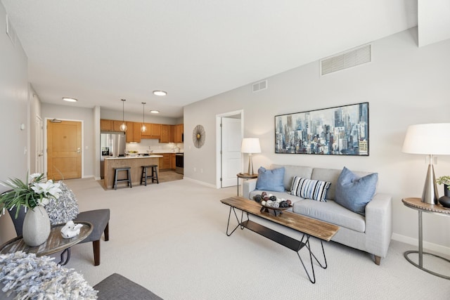 living room with light carpet, baseboards, and recessed lighting