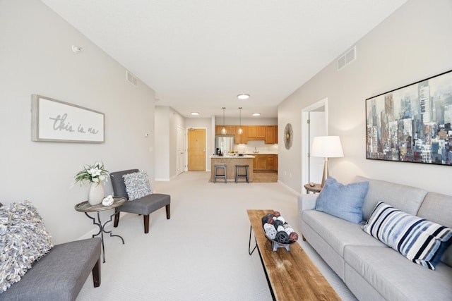 living room featuring light colored carpet, recessed lighting, and baseboards