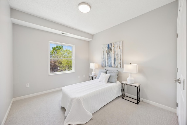 bedroom featuring light carpet and baseboards
