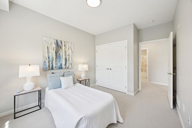 bedroom featuring a closet, carpet, and baseboards
