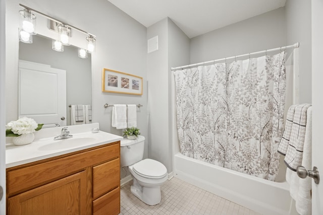bathroom with toilet, tile patterned flooring, vanity, and shower / bath combo
