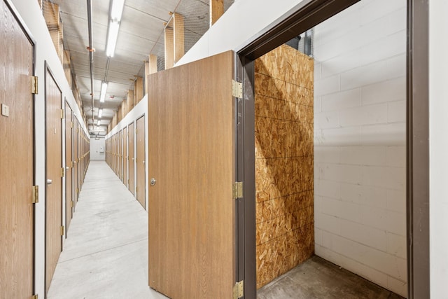 hall with concrete flooring