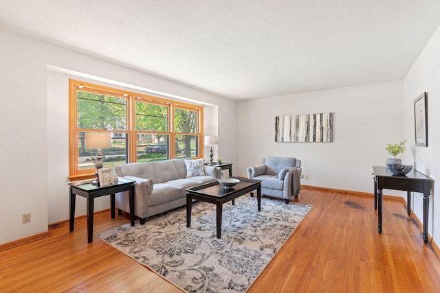 living room featuring light wood-style flooring and baseboards