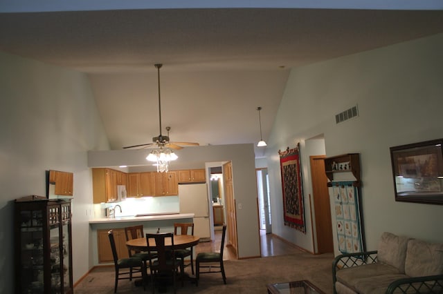 dining area with high vaulted ceiling, carpet flooring, a ceiling fan, and baseboards