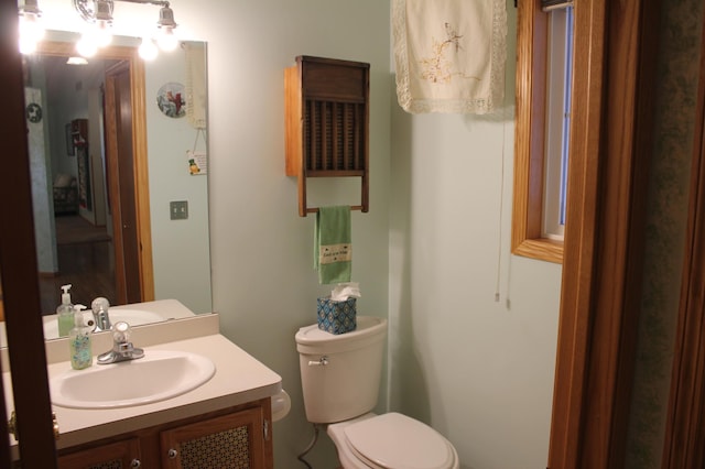bathroom featuring toilet and vanity