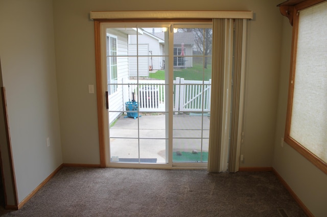 entryway with carpet and baseboards