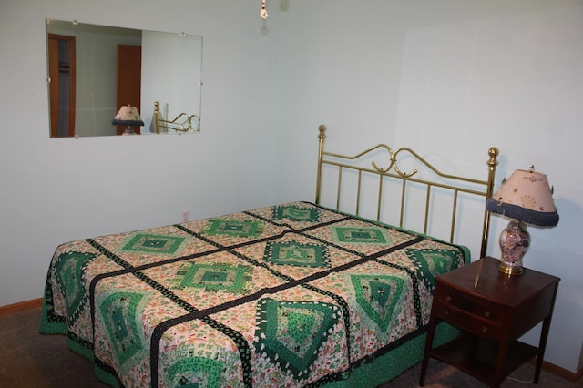 bedroom featuring carpet and baseboards