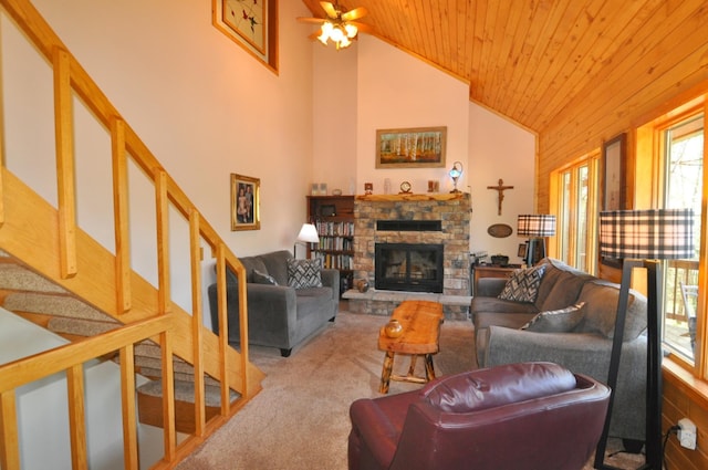 living room with carpet floors, a stone fireplace, stairs, wood ceiling, and ceiling fan