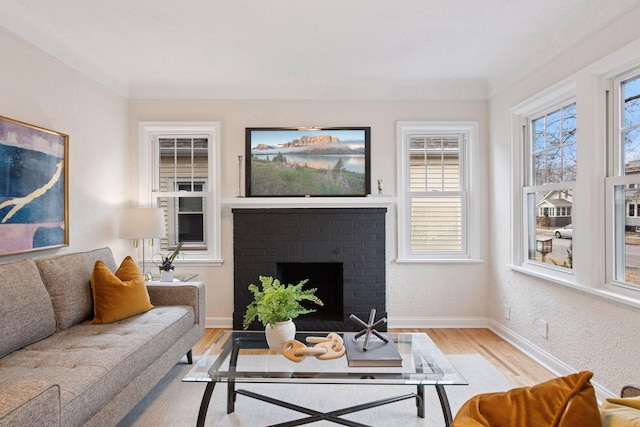 1650 Sherburne Ave, Saint Paul, MN 55104 - living room featuring light wood-style floors, baseboards, and a brick fireplace