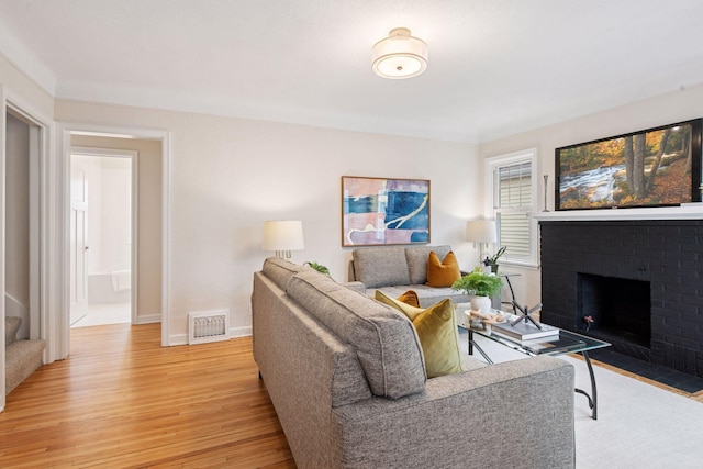 1650 Sherburne Ave, Saint Paul, MN 55104 - living area with light wood-type flooring, a fireplace, and baseboards