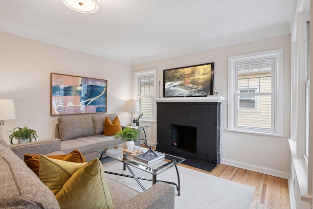1650 Sherburne Ave, Saint Paul, MN 55104 - living room featuring baseboards, wood finished floors, and a fireplace