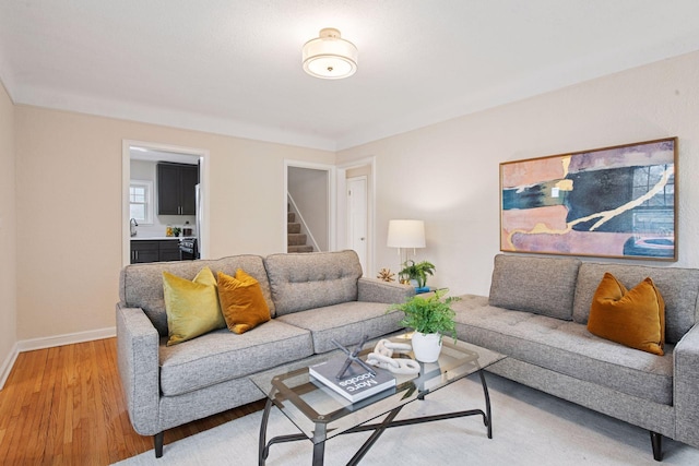 1650 Sherburne Ave, Saint Paul, MN 55104 - living room with light wood-style flooring, baseboards, and stairway