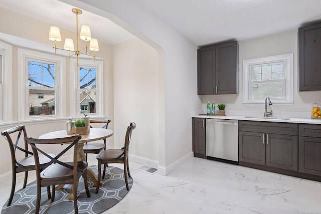 1650 Sherburne Ave, Saint Paul, MN 55104 - dining area featuring baseboards, light marble finish floors, and a chandelier