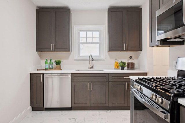 1650 Sherburne Ave, Saint Paul, MN 55104 - kitchen featuring appliances with stainless steel finishes, a sink, light marble finish flooring, light countertops, and baseboards