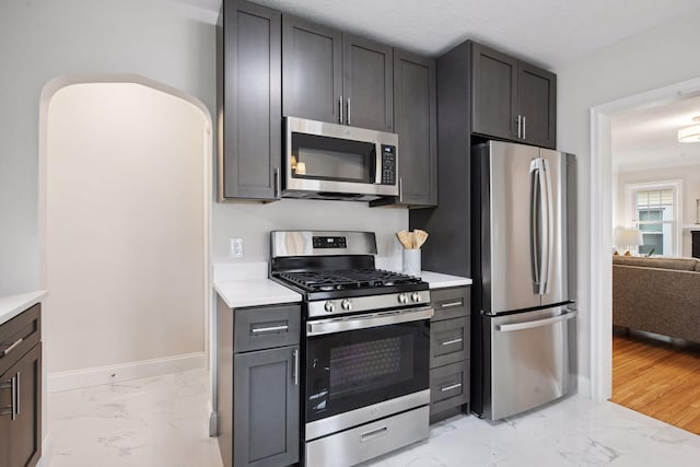 1650 Sherburne Ave, Saint Paul, MN 55104 - kitchen featuring stainless steel appliances, light marble finish floors, and light countertops