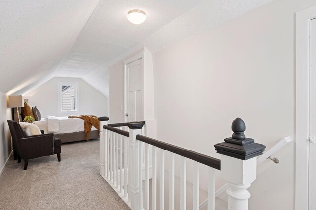 1650 Sherburne Ave, Saint Paul, MN 55104 - hall featuring light colored carpet, lofted ceiling, an upstairs landing, and a textured ceiling