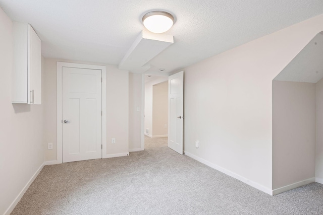 1650 Sherburne Ave, Saint Paul, MN 55104 - unfurnished bedroom featuring light colored carpet, baseboards, and a textured ceiling
