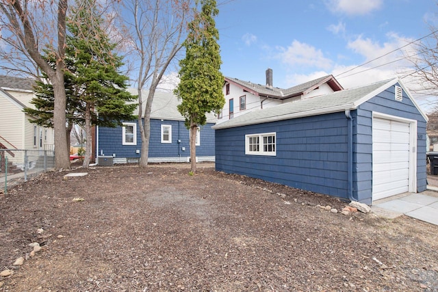 1650 Sherburne Ave, Saint Paul, MN 55104 - rear view of property with fence, a detached garage, and an outbuilding