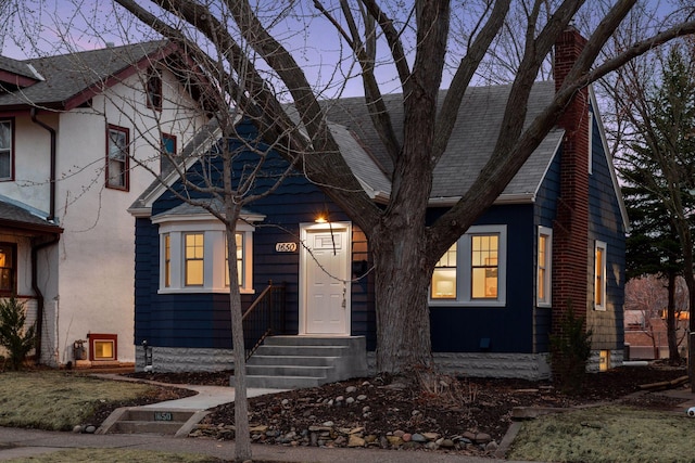 1650 Sherburne Ave, Saint Paul, MN 55104 - view of front of property with a shingled roof, a chimney, and stucco siding