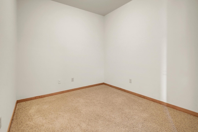 spare room with baseboards