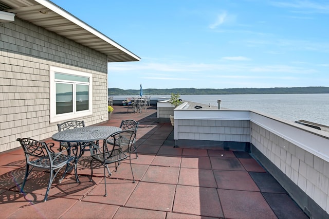 view of patio featuring outdoor dining area and a water view