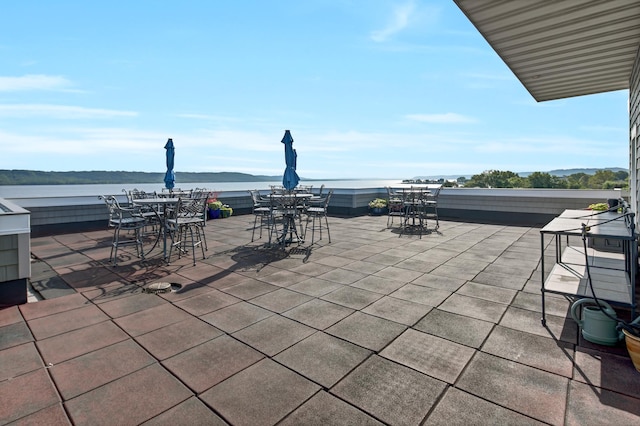 view of patio featuring outdoor dining area and a water view