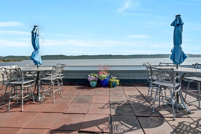 view of patio with a water view