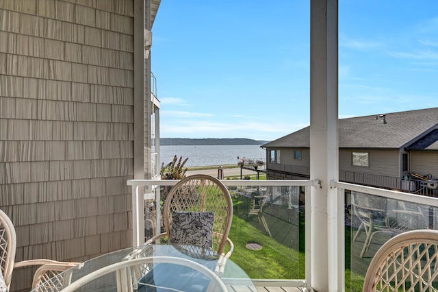 1215 Lakeshore Dr Unit 207, Lake City, MN 55041 - balcony featuring a water view and outdoor dining space