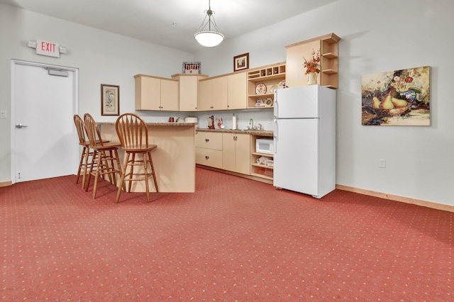 1215 Lakeshore Dr Unit 207, Lake City, MN 55041 - kitchen featuring freestanding refrigerator, open shelves, cream cabinets, and light colored carpet