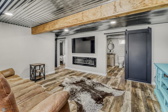 101 5th St NE, Barnesville, MN 56514 - living room featuring wood finished floors, baseboards, and a glass covered fireplace