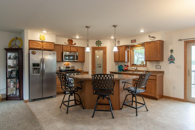 1900 White Cloud Dr E, Isle, MN 56342 - kitchen with stainless steel appliances, a center island, a breakfast bar area, brown cabinets, and recessed lighting