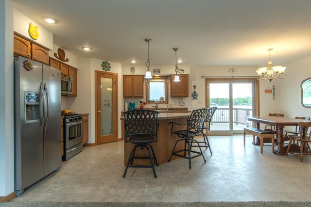 1900 White Cloud Dr E, Isle, MN 56342 - kitchen with stainless steel appliances, a chandelier, a kitchen breakfast bar, recessed lighting, and decorative light fixtures