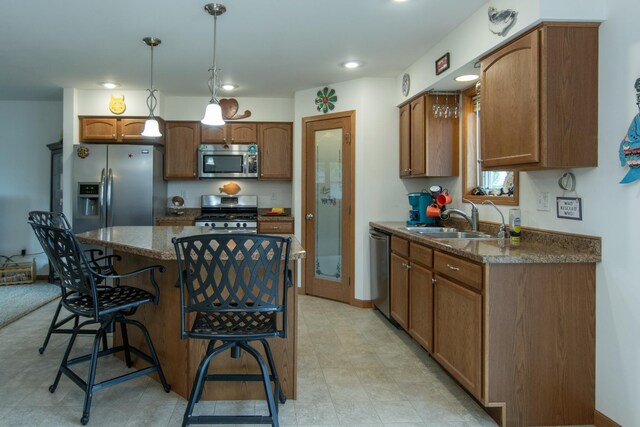 1900 White Cloud Dr E, Isle, MN 56342 - kitchen with appliances with stainless steel finishes, a sink, a kitchen island, a kitchen breakfast bar, and decorative light fixtures