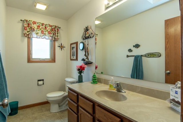 1900 White Cloud Dr E, Isle, MN 56342 - bathroom featuring toilet, vanity, tile patterned floors, and baseboards