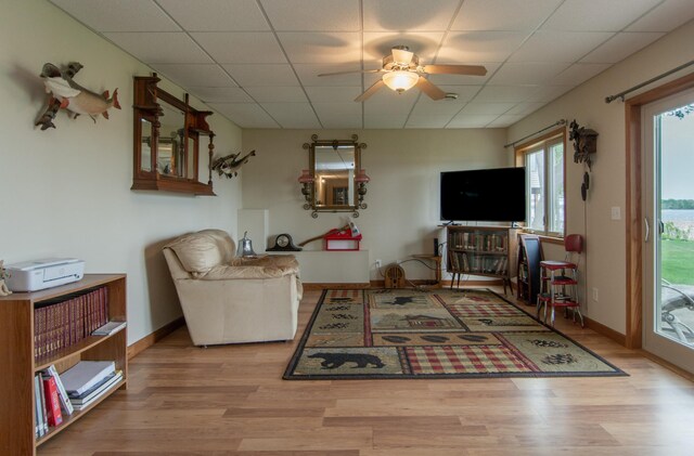 1900 White Cloud Dr E, Isle, MN 56342 - living room with wood finished floors, a ceiling fan, a drop ceiling, and baseboards