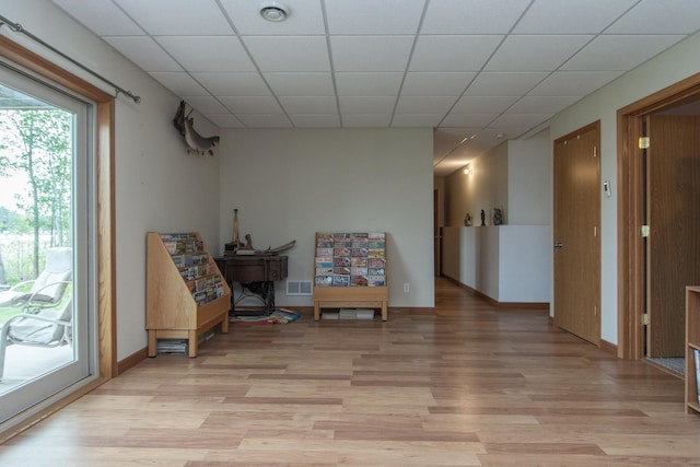 1900 White Cloud Dr E, Isle, MN 56342 - living area featuring light wood-type flooring, baseboards, and a drop ceiling