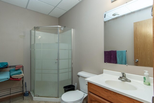 1900 White Cloud Dr E, Isle, MN 56342 - full bath featuring a shower stall, toilet, vanity, a paneled ceiling, and tile patterned floors