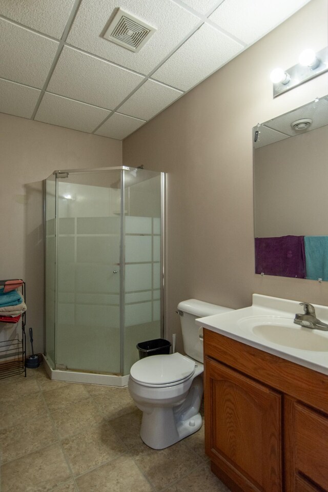 1900 White Cloud Dr E, Isle, MN 56342 - bathroom featuring a drop ceiling, vanity, a stall shower, toilet, and tile patterned flooring