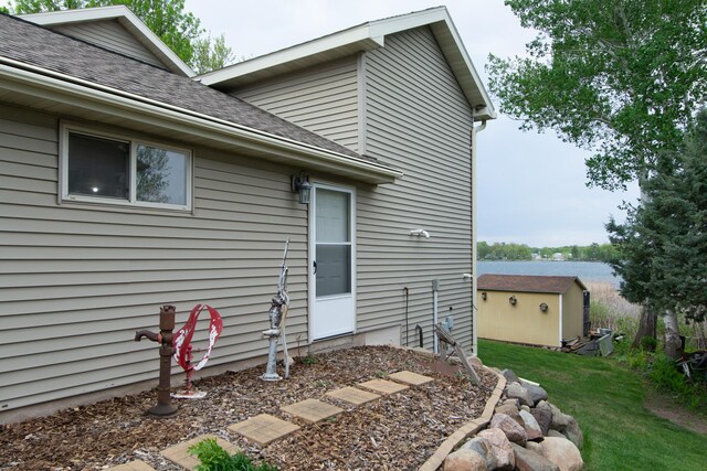 1900 White Cloud Dr E, Isle, MN 56342 - back of property with roof with shingles, a yard, an outbuilding, and a shed