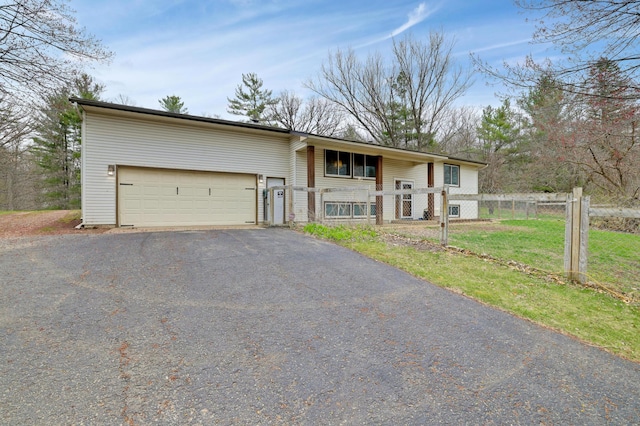 W12798 State Road 35, Prescott, WI 54021 - raised ranch with asphalt driveway, an attached garage, and covered porch