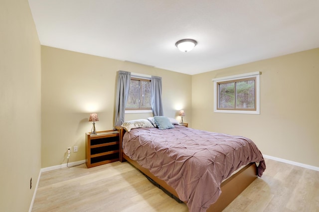 W12798 State Road 35, Prescott, WI 54021 - bedroom featuring wood finished floors, multiple windows, and baseboards