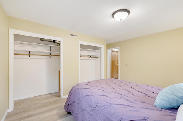 W12798 State Road 35, Prescott, WI 54021 - bedroom with two closets, light wood finished floors, and baseboards